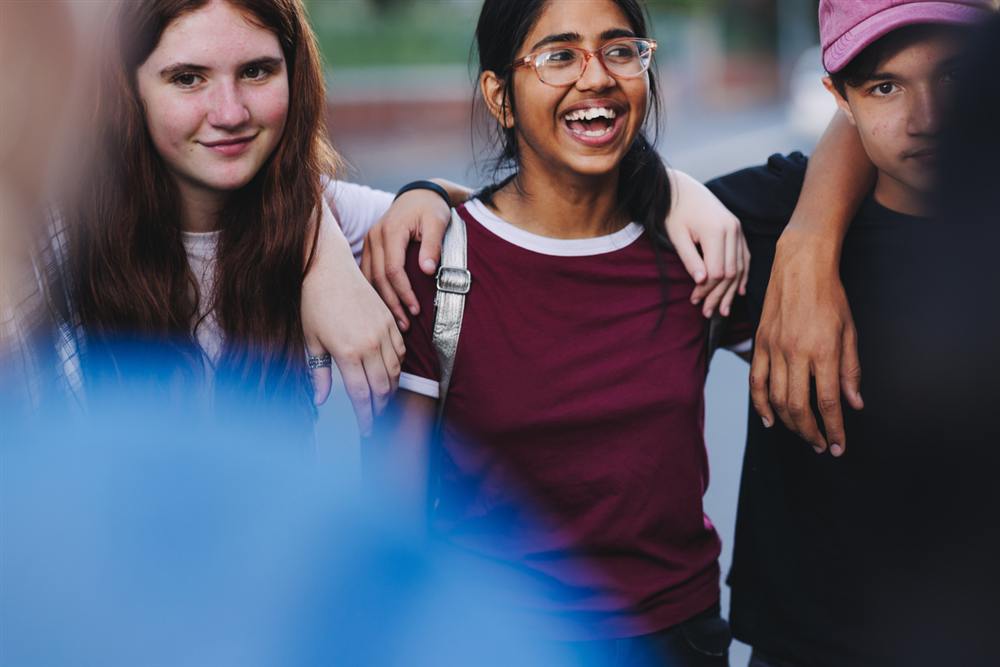 R.I.S.E. College students laughing together